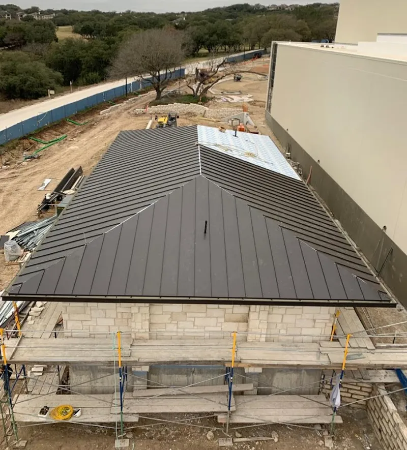 Metal roof new construction with scaffolding in Byron