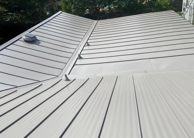 Solar attic fan installed on a metal roof for Roof Ventilation in Byron